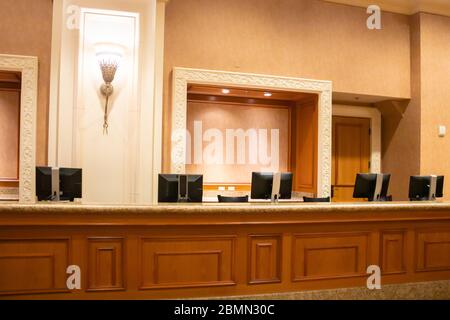 Empty front desk in reception area of unknown hotel lobby Stock Photo
