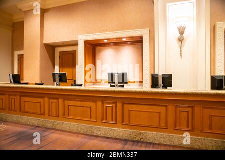 Empty front desk in reception area of unknown hotel lobby Stock Photo