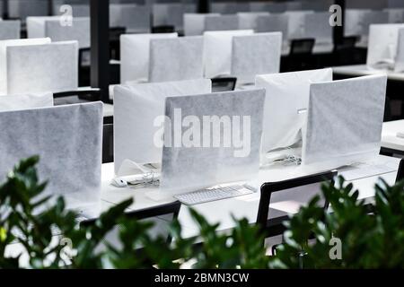 Big office with covered computers with no workers Stock Photo