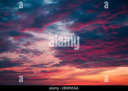 Pink sky with purple clouds during sunset Stock Photo