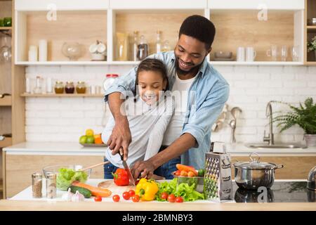 Vegan family cooking healthy food together at home Stock Photo