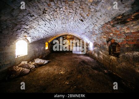 Abandoned empty old dark underground vaulted cellar Stock Photo