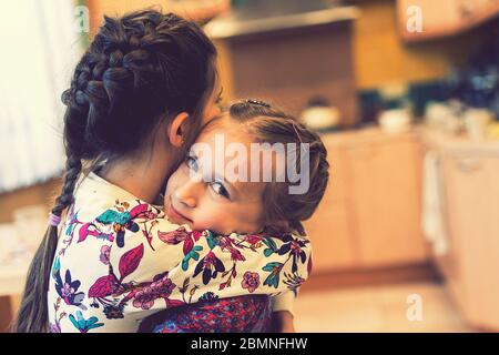 Two little girls sisters hugging and having fun in park. Happy cute ...