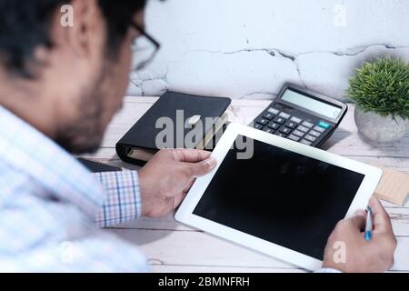 young man working on digital tablet with empty screen  Stock Photo