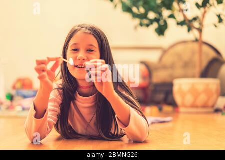 Girl playing with matches. Dangerous situation at home. A small child plays with matches, a fire, a fire flares up, danger, child and matches, lucifer Stock Photo