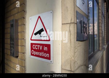 A 'CCTV in operation' sign on a wall in an urban street in central London. Stock Photo