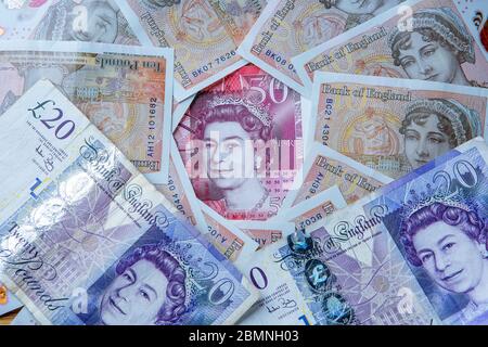 Fifty Pound note surrounded by Ten and Twenty Pound Notes Stock Photo