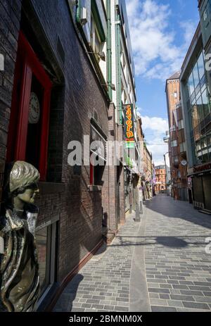 John Lennon statue looks out on an empty Mathew Street due to the Liverpool pandemic lockdown Stock Photo