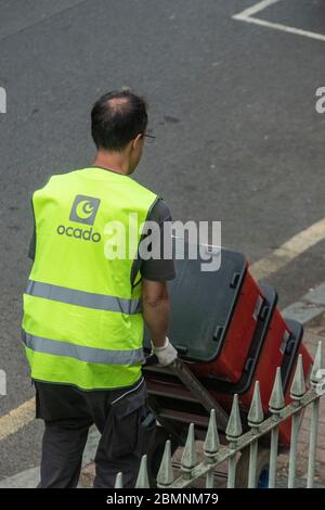 An Ocado employee unpacks supermarket shopping for a home delivery Stock Photo