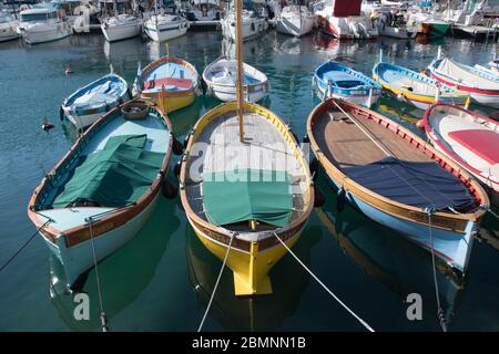 Nice, France, 25th of February 2020: Boats in the port of Nice in southeastern France,department Alpes-maritimes, with colorful buildings in the backg Stock Photo