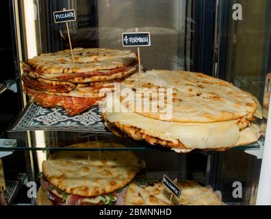 Pita with ham, cheese and salami display at the market. Italian street food Stock Photo