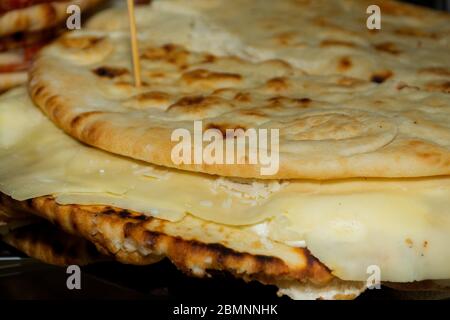 Pita with ham, cheese and salami display at the market. Italian street food Stock Photo