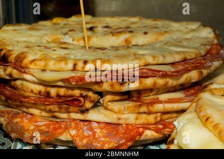 Pita with ham, cheese and salami display at the market. Italian street food Stock Photo