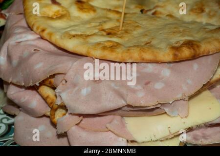 Pita with ham, cheese and salami display at the market. Italian street food Stock Photo