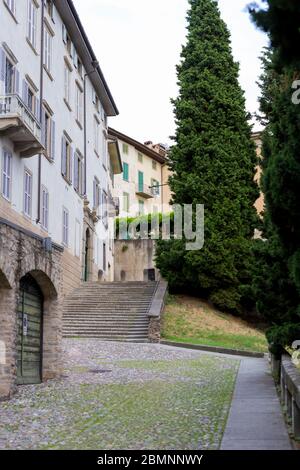 Traditional narrow Italian street with staircase and no people in Bergamo historical center, Italy. Medieval buildings. There's no one on the street. Stock Photo