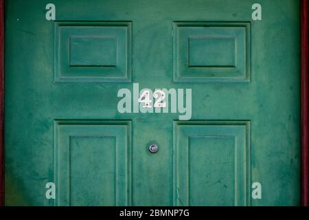 House number 42 on a green wooden front door