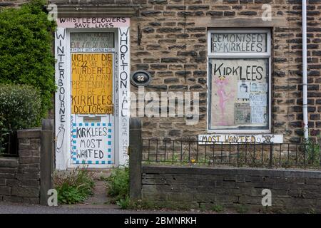 Meltham, UK - May 5 2020: A house in Meltham covered with writing and signs protesting against Kirklees Council, including references to NHS funded ho Stock Photo