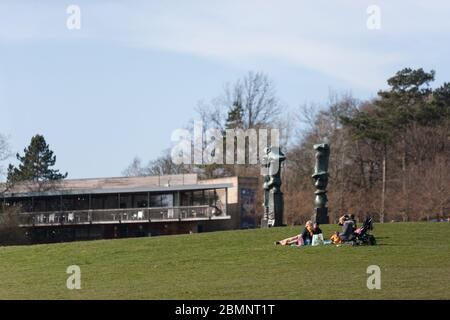 YORKSHIRE SCULPTURE PARK, WEST YORKSHIRE, UK - MARCH 22: A family picnic next to Henry Moore's 'Upright Motives' at Yorkshire Sculpture Park on Mother Stock Photo