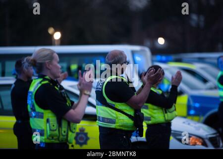 HUDDERSFIELD, WEST YORKSHIRE, UK - APRIL 9: Officers from West Yorkshire Police applaud NHS workers outside Huddersfield Royal Infirmary Stock Photo