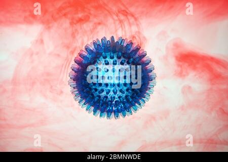 Rubber ball, simulation, coronavirus, pandemic bacteria model on red-white background in blood. Copy space. Stock Photo