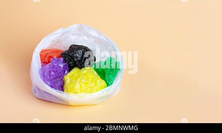 Collection of various plastic bags on a beige background. Stock Photo