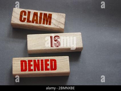 Claim is denied on Wooden Blocks on dark grey background with copyspace. The answer is No. Business financing sponsorship concept Stock Photo
