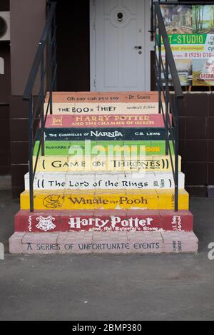 Moscow, Russia - March 22, 2020: A multi-colored staircase at the English language school. On the steps are written Harry Potter, The Chronicles of Na Stock Photo