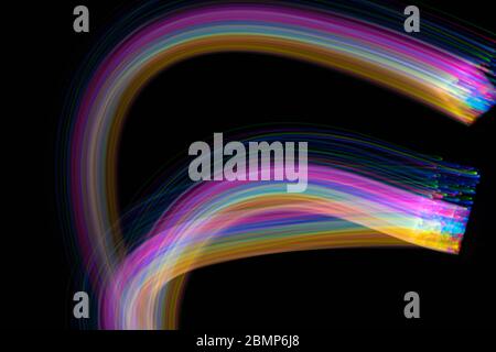 multi coloured neon light painting photography, long exposure, ripples and waves against on background Stock Photo
