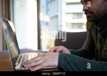 man working online at home or study using laptop on sofa. Stay home quarantine, Remote working Stock Photo