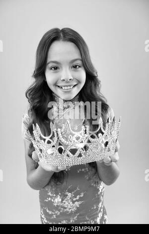 i am so happy. miss japan queen winner. selfish champion kid. happy kid chinese dress wear crown. portrait of pride. japanese kimono. child national costume of japan. small asian girl long curly hair. Stock Photo