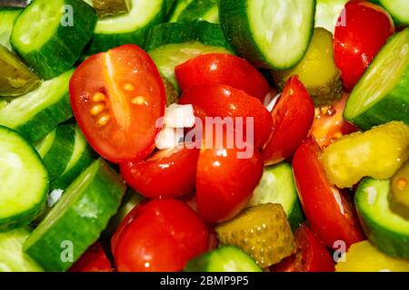 Vegetable salad sliced tomatoes, cucumbers, onions and pickles. Close up. Healthy food, fitness diet Stock Photo