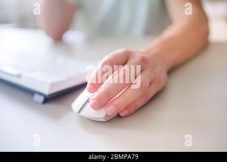 close up hand business man using mouse and laptop in office with morning light. Stock Photo