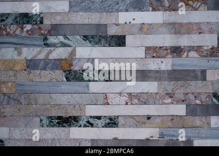 Texture of the wall is lined with marble tiles. Stock Photo