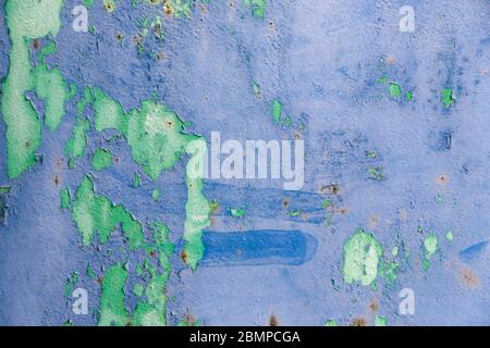 Old ragged cracked blue and green painted surface with rusty stains. Background texture Stock Photo