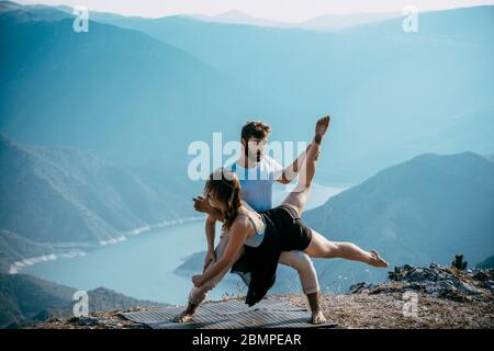 Young beautiful barefoot couple dancer practicing modern dance Stock Photo