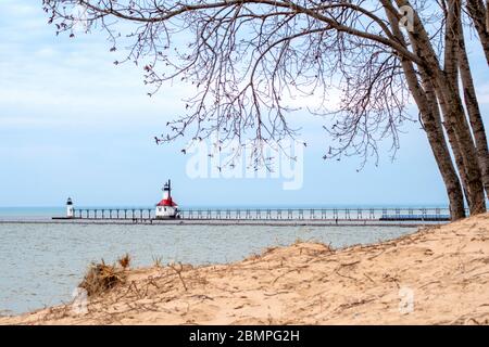 The walkway and beach near the St Joseph light house sits empty on a warm spring day, as the whole state stays home under lock down orders Stock Photo