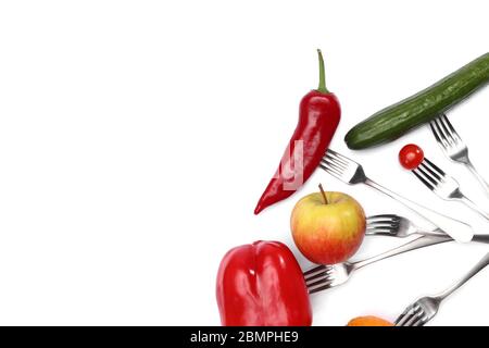 A healthy diet food. fresh cherry tomato, red pepper, cucumber, apple and orange fruits on forks on white background. Healthy eating and vegetarian Stock Photo