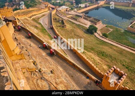 Tourists riding elephants on ascend to Amer fort Stock Photo