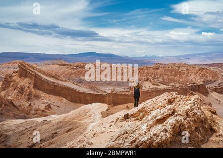 Female traveler exploring the Valley of the Moon (Spanish: Valle de La Luna ) in the Atacama Desert, Chile, South America. Stock Photo