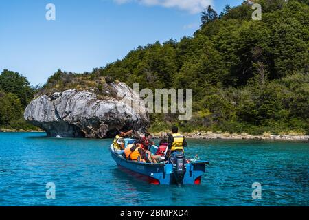 Tourists exploring the Marble Caves (Spanish: Cuevas de Marmol ), a series of naturally sculpted caves and rock formations in Patagonia, Chile. Stock Photo