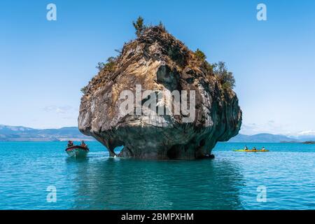 Tourists exploring the Marble Caves, a series of naturally sculpted caves and rock formations on General Carrera Lake in Patagonia, Chile. Stock Photo