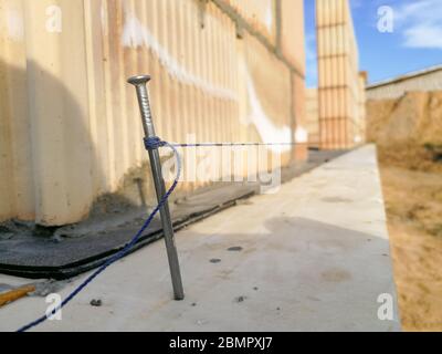Nail and string for ceramic building block construction leveling in construction site Stock Photo