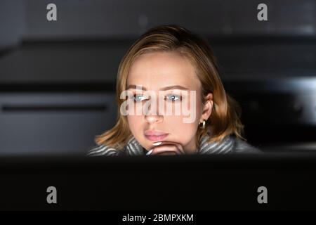 Close up of young woman working on desktop pc late at night at home office, can not sleep, news search about coronavirus or sharing social media. Free Stock Photo
