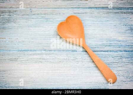 Wooden spoon on wooden table background , top view / Coffee spoon heart shape , Love health or love cooking concept Stock Photo