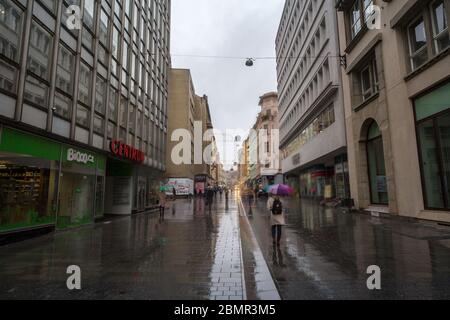 BRNO, CZECHIA - NOVEMBER 5, 2019: Crowd of people walking in a pedestrian street of Brno, Koblizna Ulice, during a rainy afternoon surrounded by shops Stock Photo