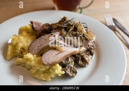 Pulled pork with mashed potato and mushroom sauce meal on white plate Stock Photo
