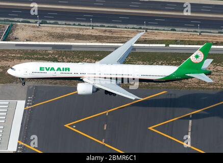 Eva Air Boeing 777 on final approach to Los Angeles International Airport aerial view. Aircraft registered as B-16713. Airplane over runway chevrons. Stock Photo