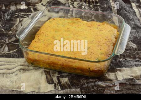 Cooked casserole with cheese cornbread crust topping in glass baking pan Stock Photo