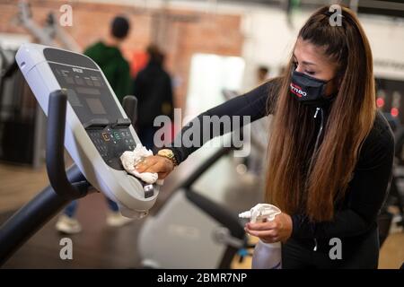 cologne germany 11th may 2020 a woman with a mouth guard is training on a leg press in a fitness studio of the mcfit chain in nrw the first gyms have reopened