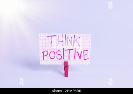 Conceptual hand writing showing Think Positive. Concept meaning The tendency to be positive or optimistic in attitude Colored clothespin rectangle sha Stock Photo